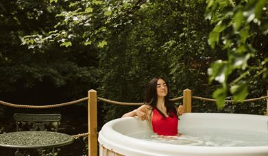 Galgorm Riverside Cottage with outdoor hot tub overlooking the river