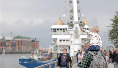 Crowds gather along Queens Quay in Belfast to enjoy Belfast Maritime Festival.