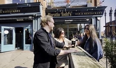 Group sitting outside Horatio Todd's having a drink and chatting 