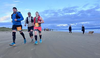 Giants Causeway Coast Marathon runners on beach 