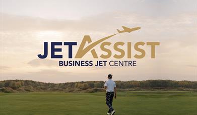 Jet Assist Logo on golf course background with person holding golf club