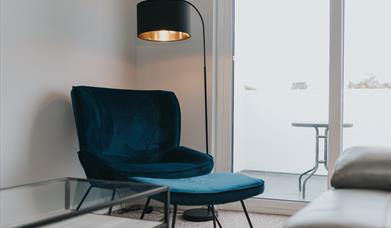 Lounge chair and lamp beside patio window
