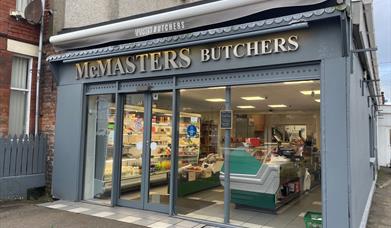 Grey shop frontage of McMasters Butchers in Whitehead