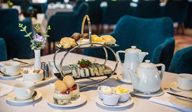 Afternoon tea in the Ross Park Hotel served on silver stand with white crockery and tablecloth