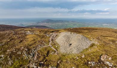 Birds eye view showing Slieve Gullion Cairn from top and surrounding landscape in the background.