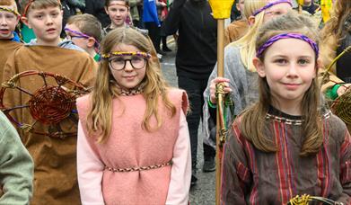 Performers walking down Market Street in Downpatrick as part of the St Patrick's Day parade.