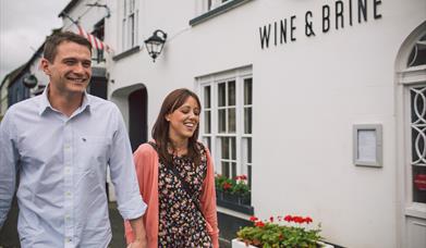 Couple walking outside the Wine & Brine restaurant