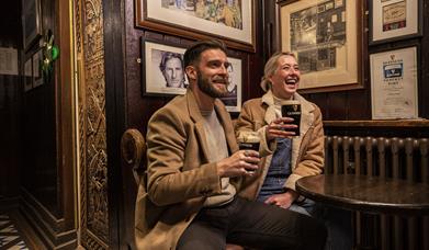 2 people enjoying a Guinness in Blakes of the Hollow