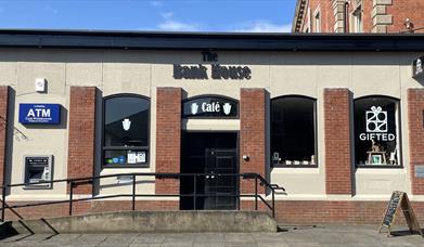 Building exterior of the red brick Bank House Cafe