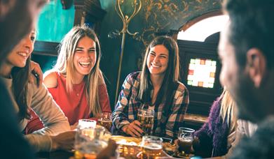 Ceili & Craic in the Mournes, group of people in bar seated at a table