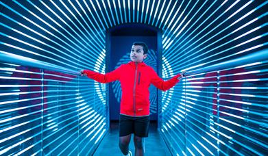 A mesmerising exhibition at W5 with a young boy walking through an optical illusion