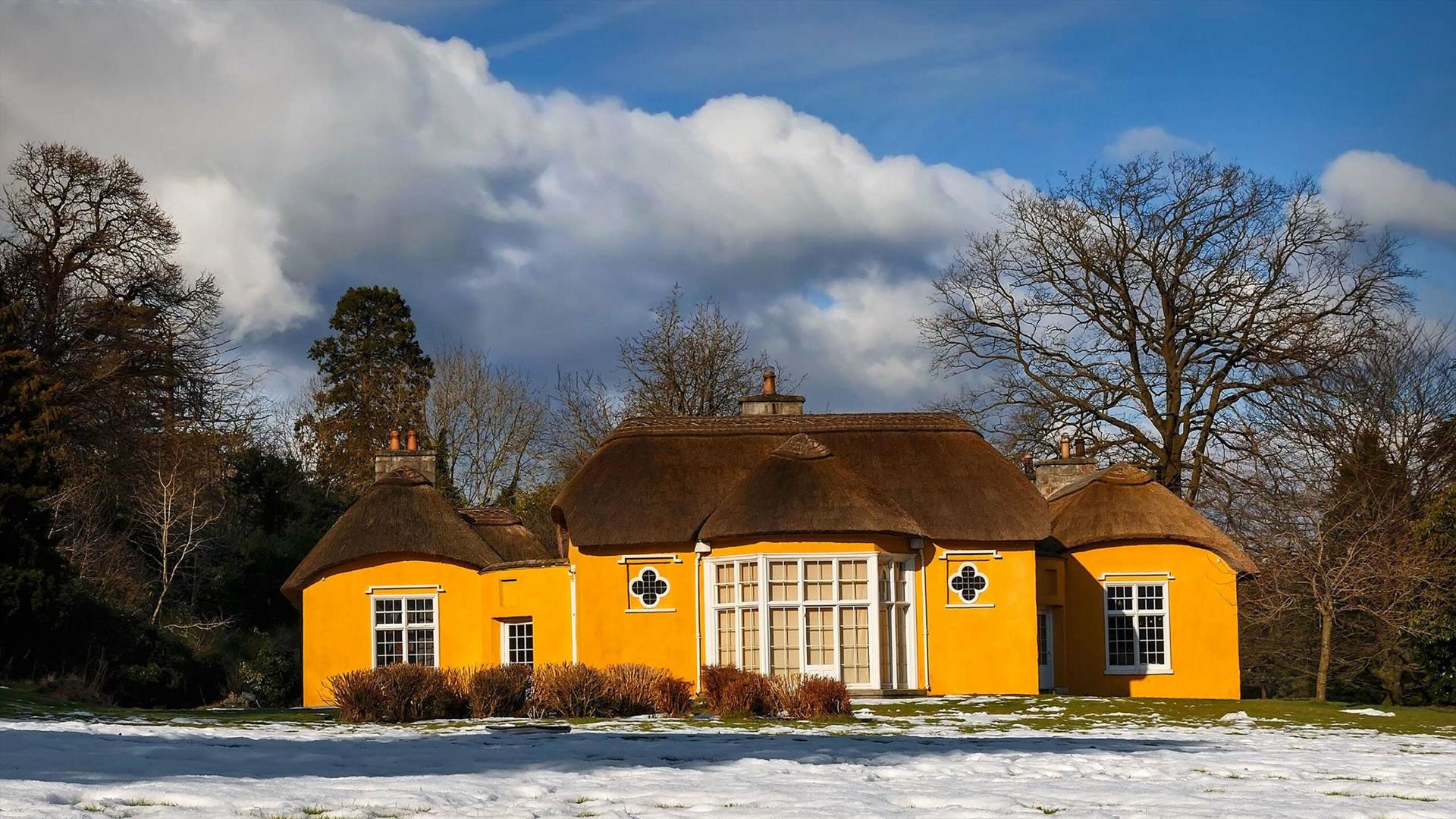 Image credit: Alan Hopps
Derrymore house. A bright yellow cottage with a thatched roof.