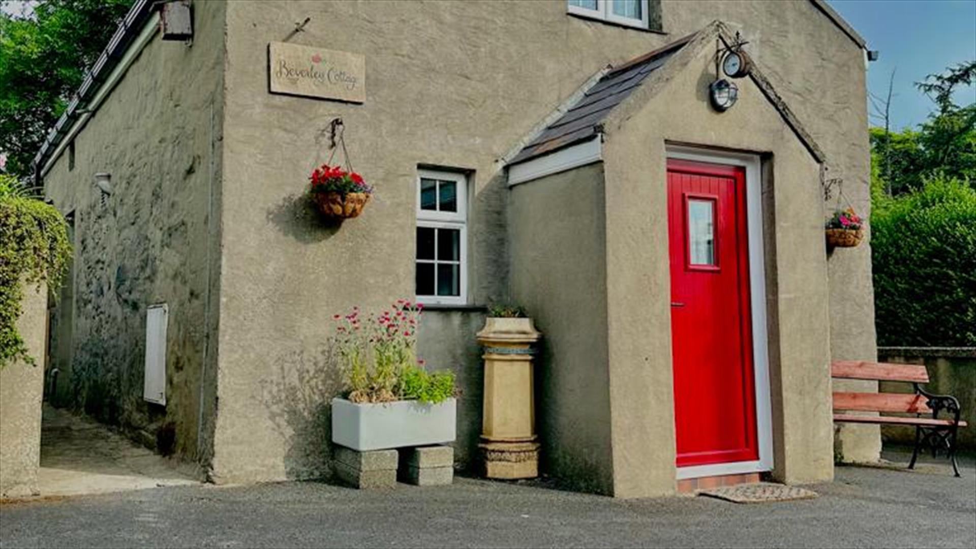 Exterior of cottage with summer seat