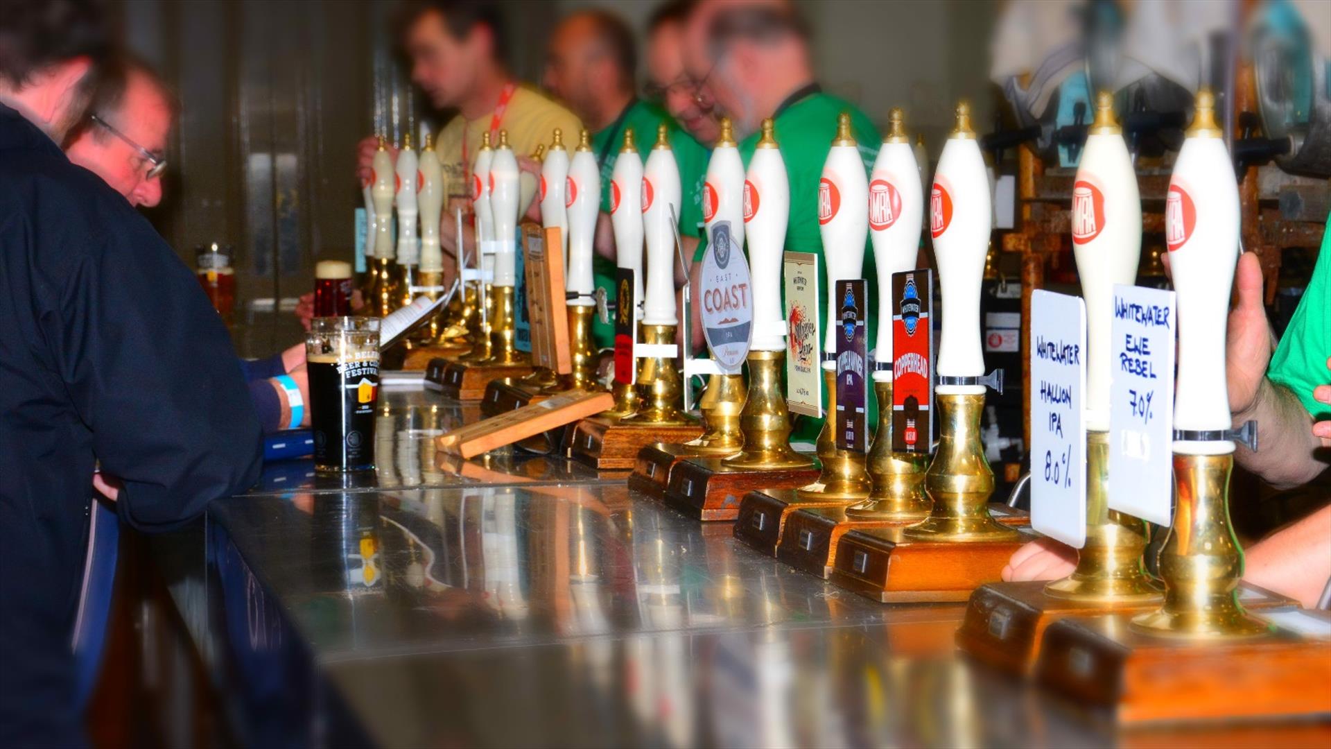 A bar with a row of hand pumps behind it