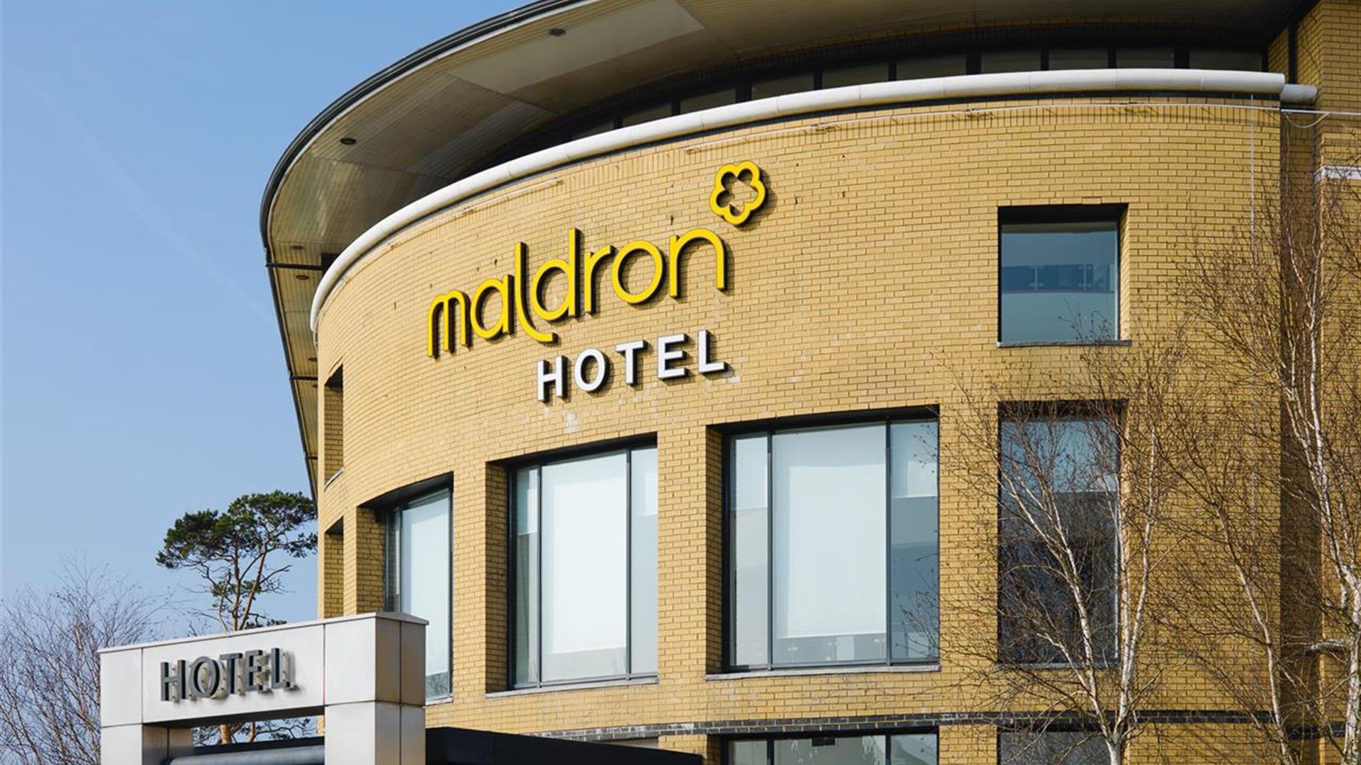 A view of the top rounded wall and sign of the Maldron hotel at Belfast international airport.