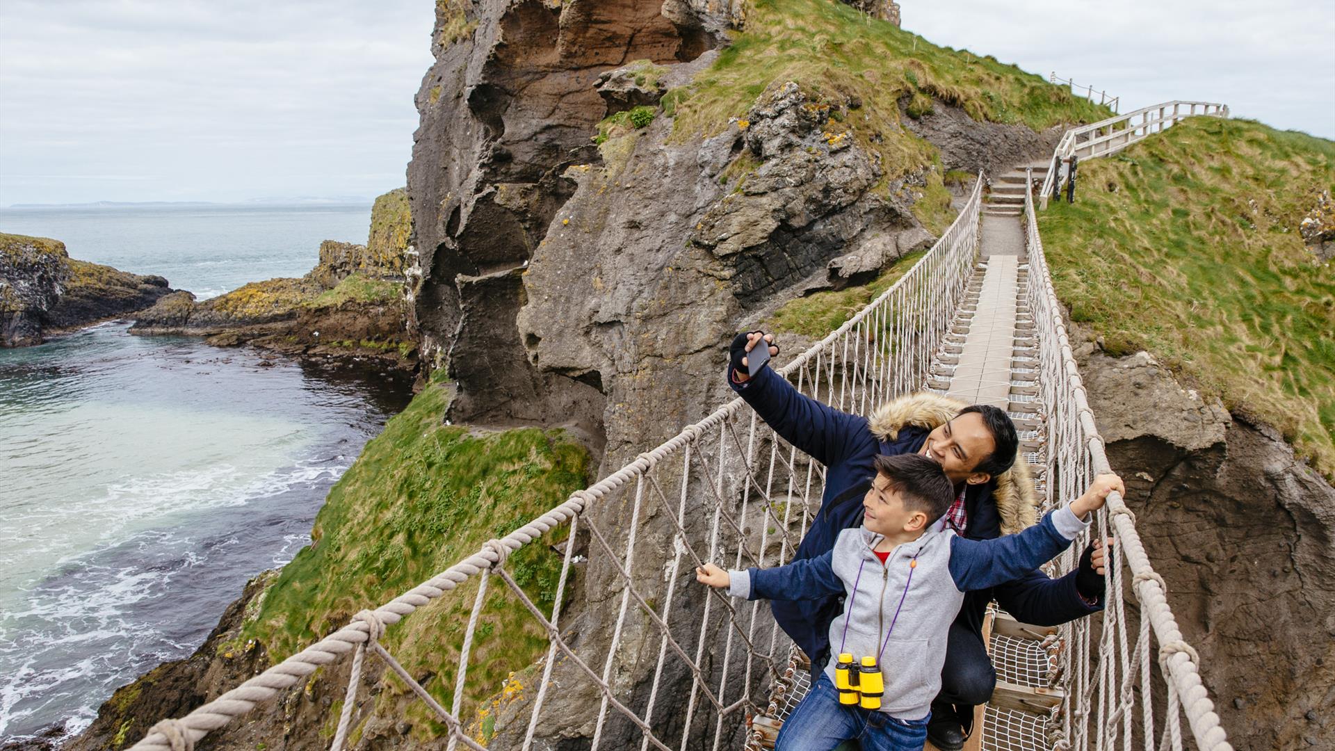 Father and Son on Carrick-a-Rede Rope Bridge taking a selfie