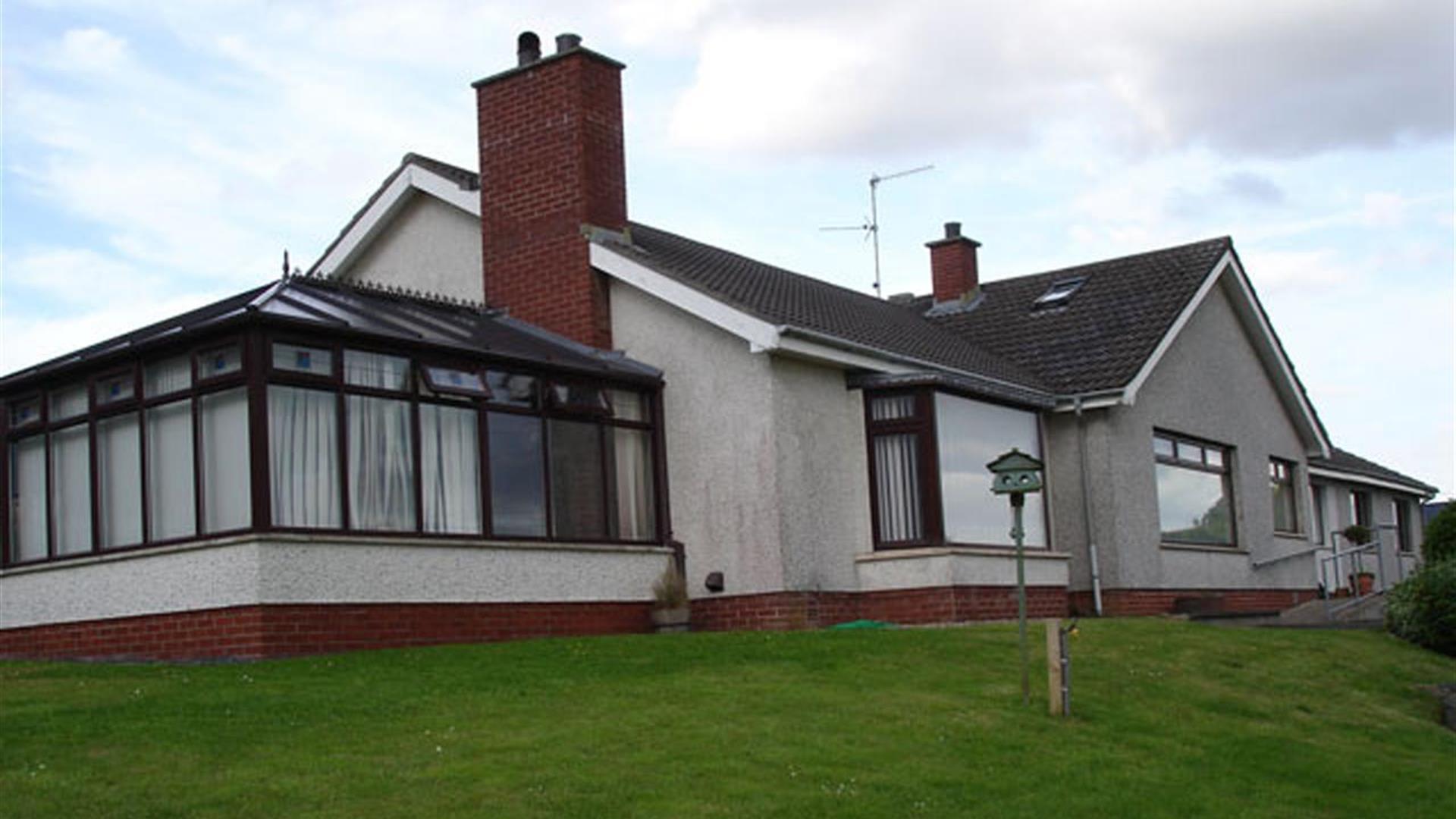 Image shows outside view of the property with sun room