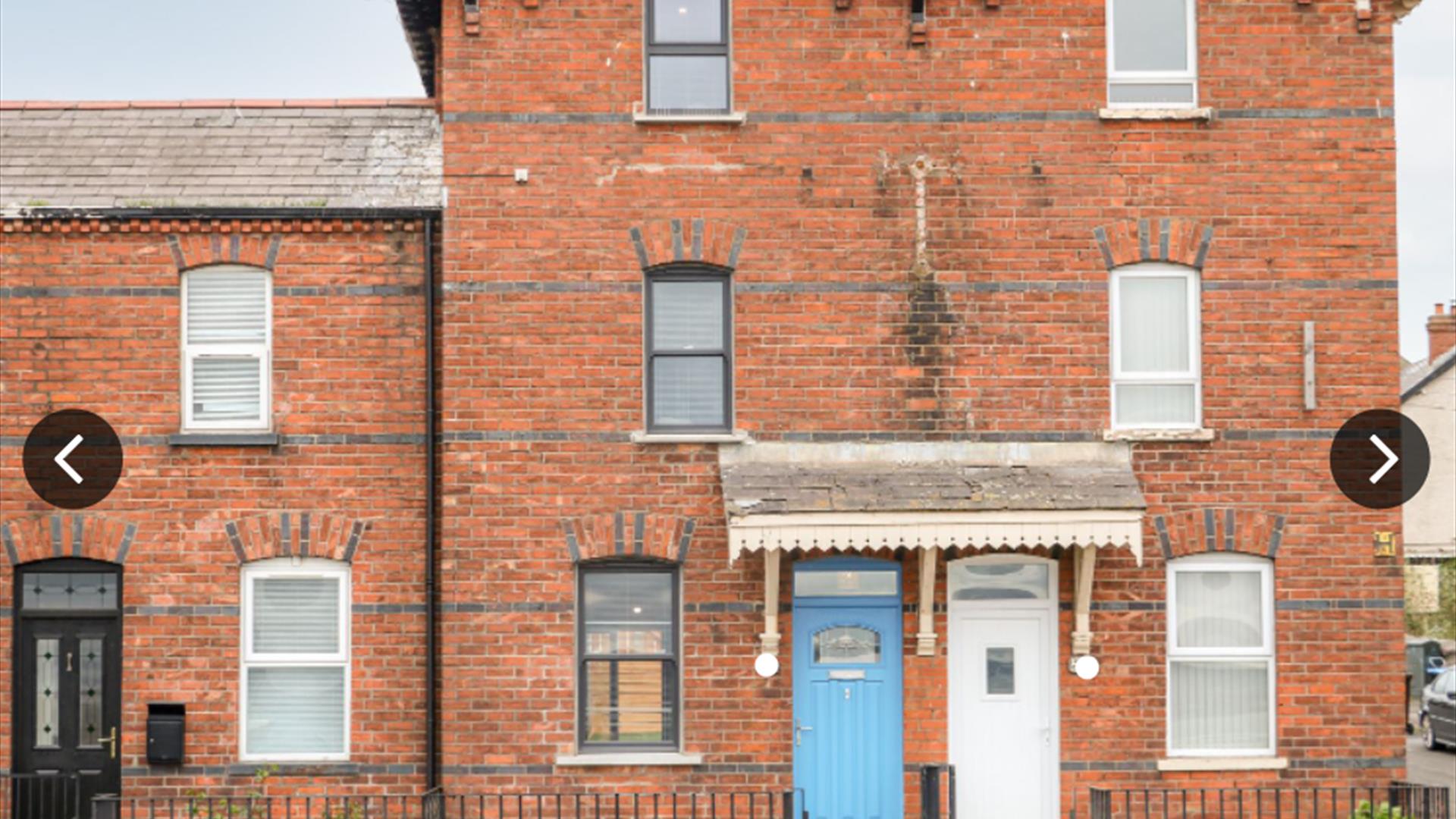 Front of house showing blue front door and all 3 storeys