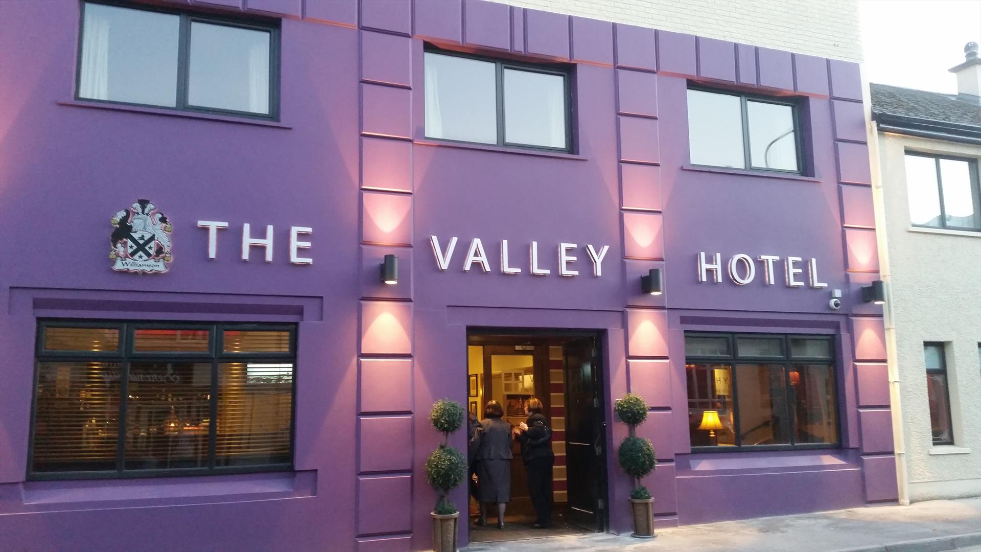 outside image of The Valley Hotel, with purple walls and black window frames and door