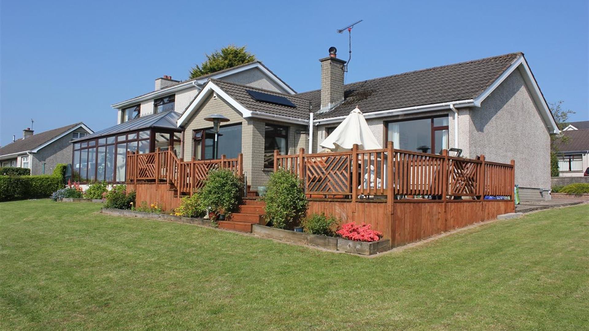 Back of Cairnview Bed and Breakfast with a decking and view of conservatory.