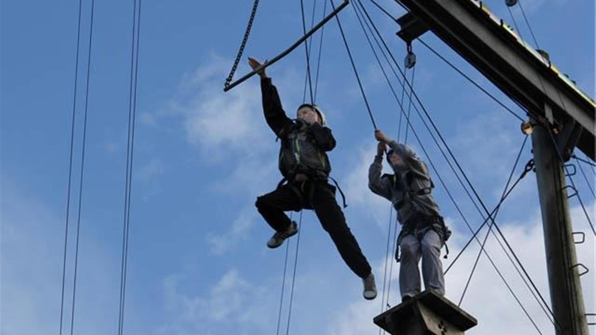 Two people undertaking aerial trekking