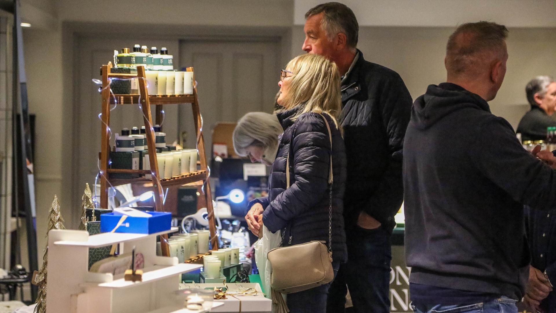People browsing indoor market stalls