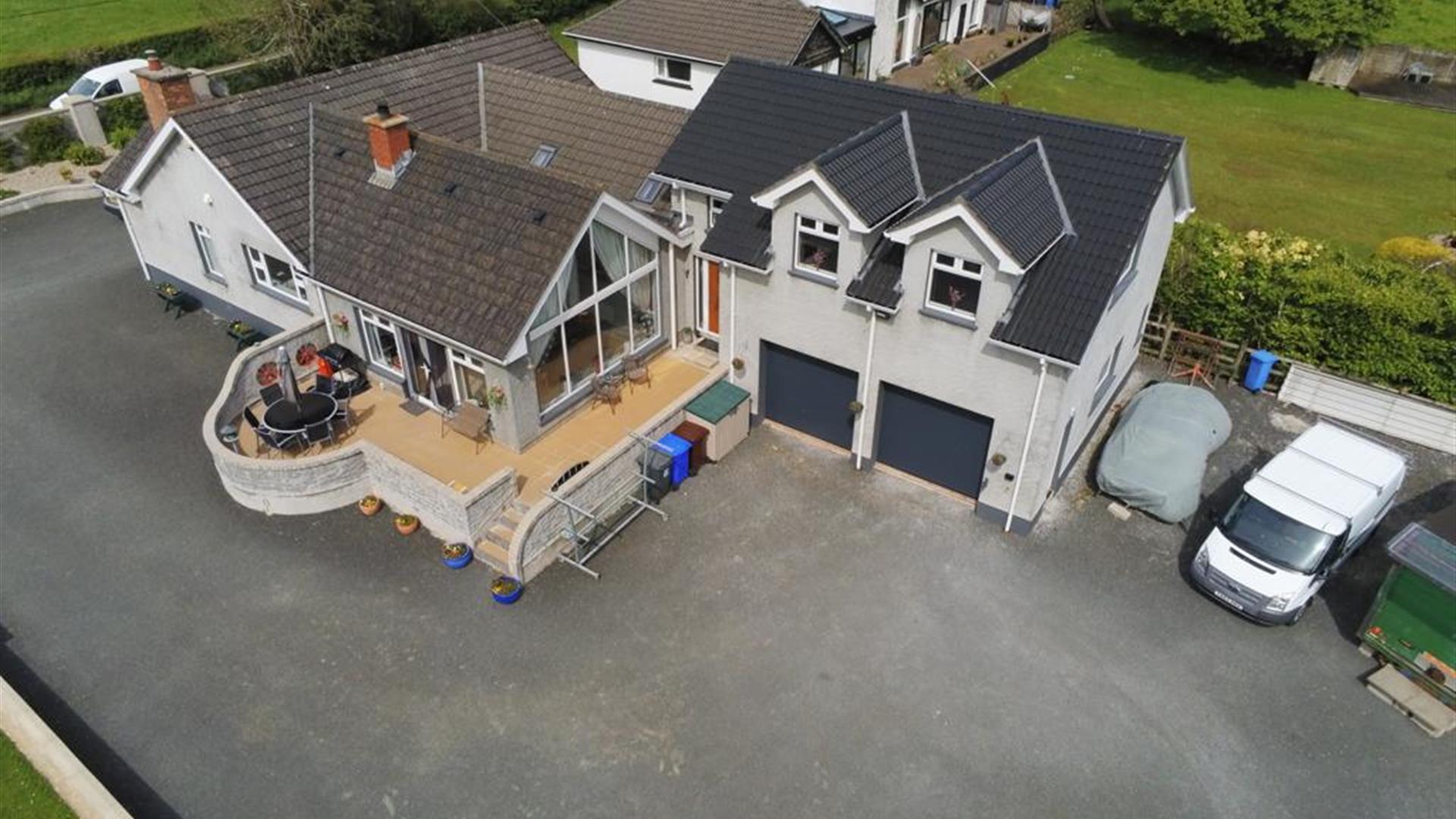 An arial view of a large country house with an annexe.