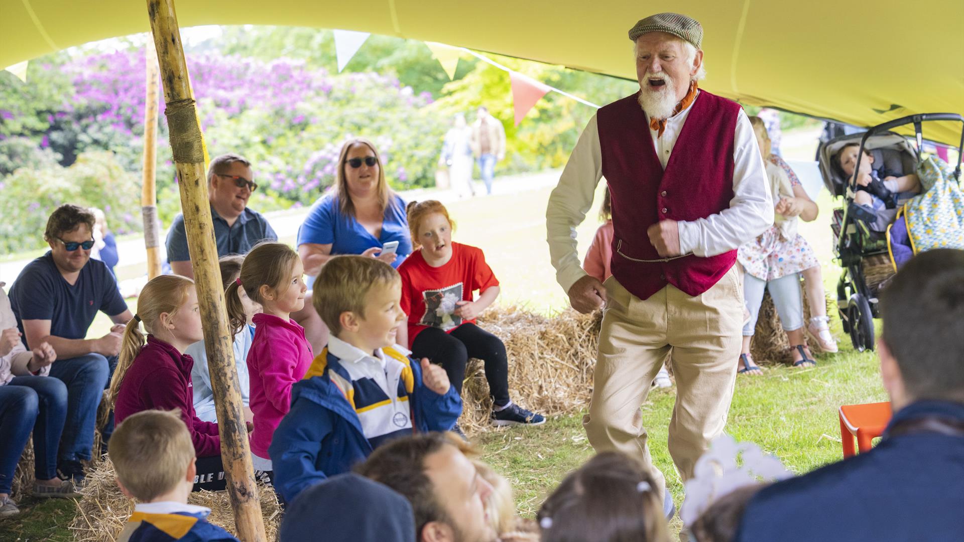 A storyteller is talking to children on the grounds of Hillsborough Castle and Gardens