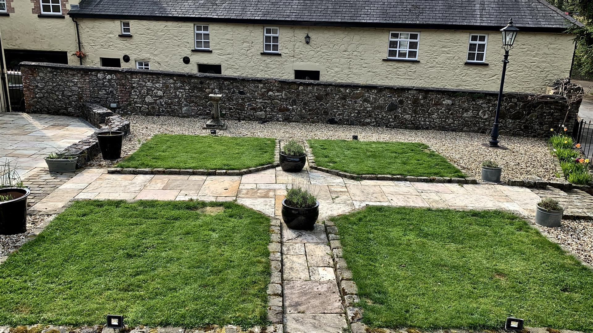 Image shows back of property with landscaped garden area