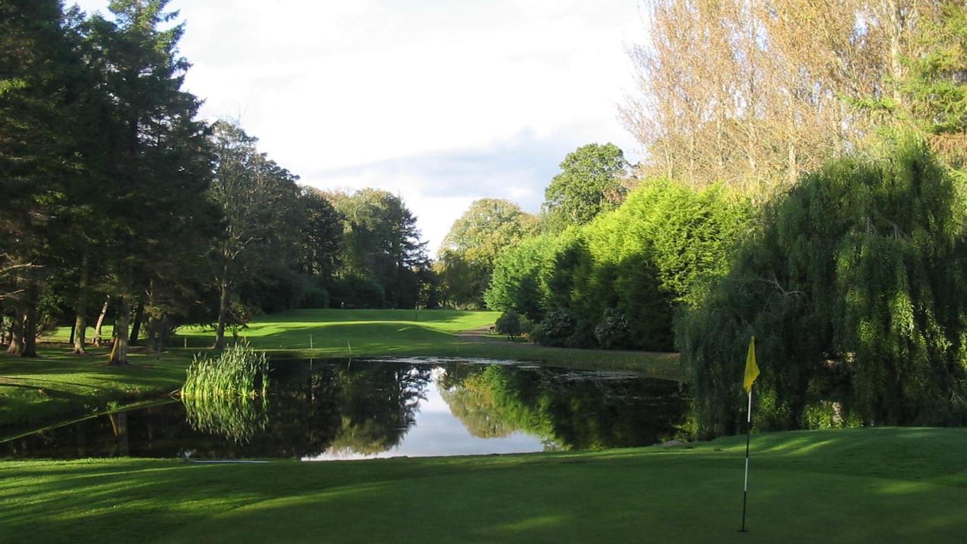 Image is of golf course with lake around it
