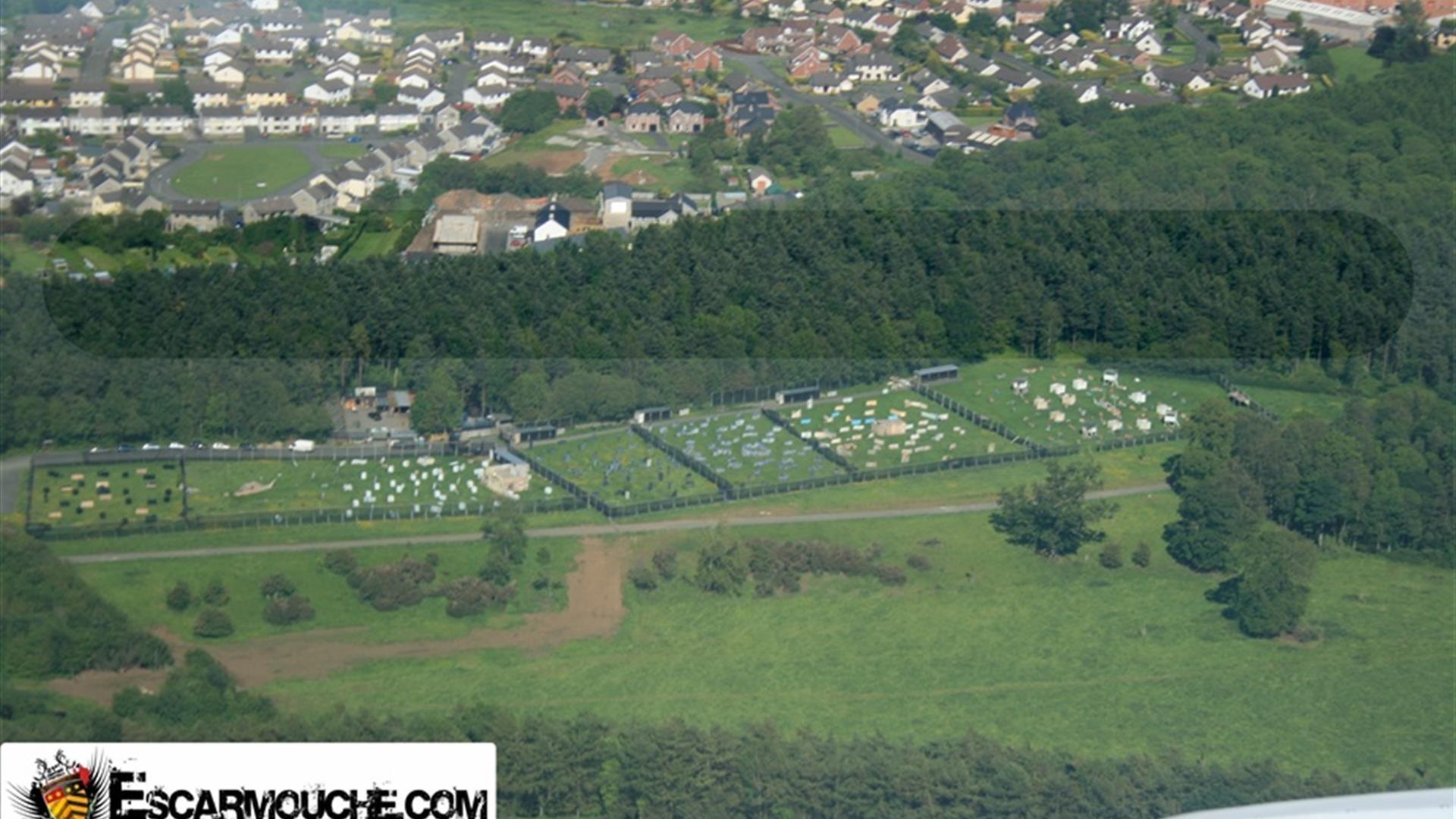 An arial view of a large activity centre next to a village.