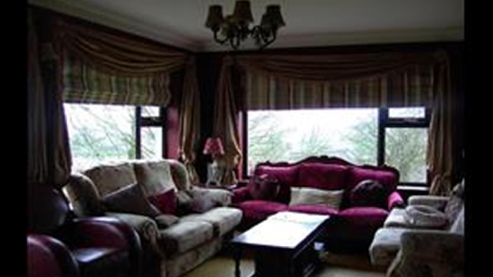 Image shows lounge with sofas and coffee table