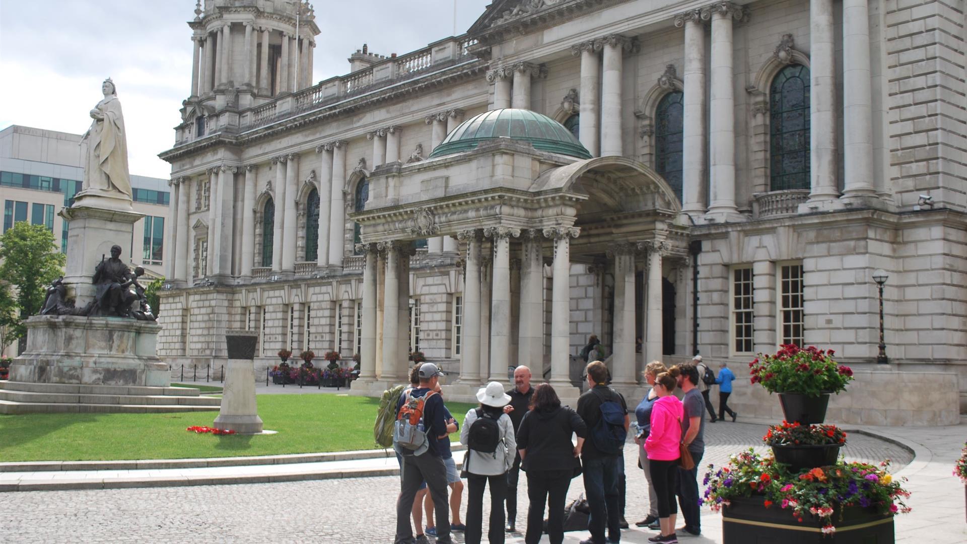 DC Tours taking a group of guests on a walking tour outside Belfast City Hall