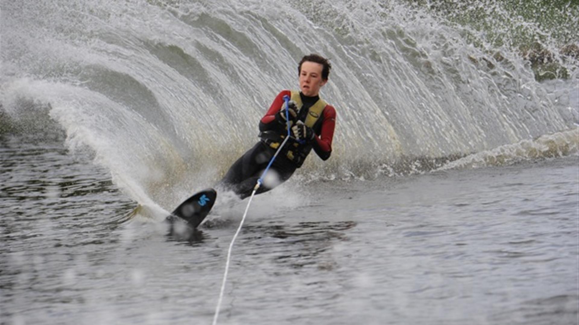 Image is of a man water-skiing