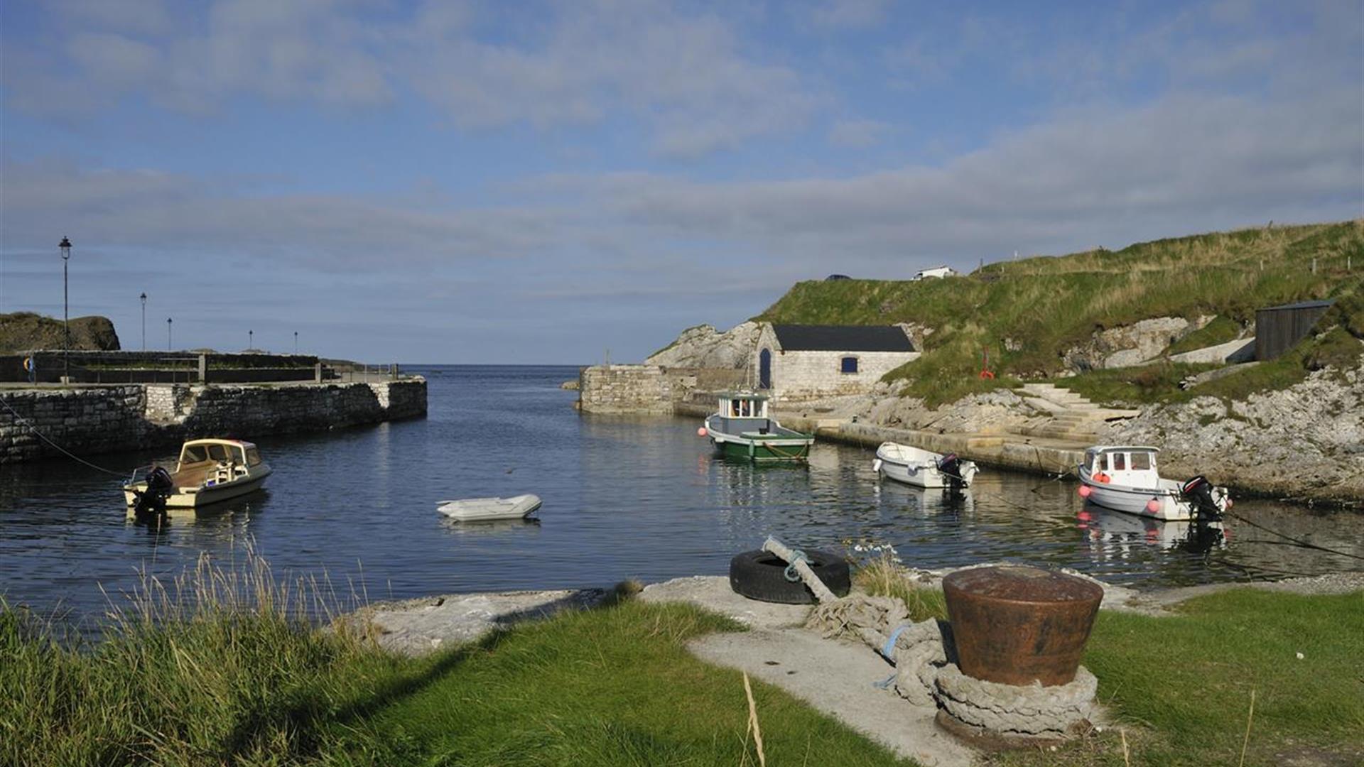 Small boats docked at Ballintoy Harbour