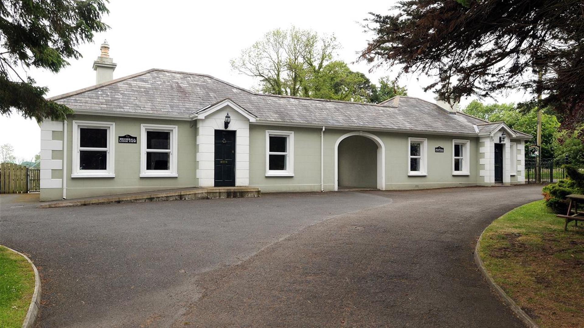 Image shows front of property with gravel driveway