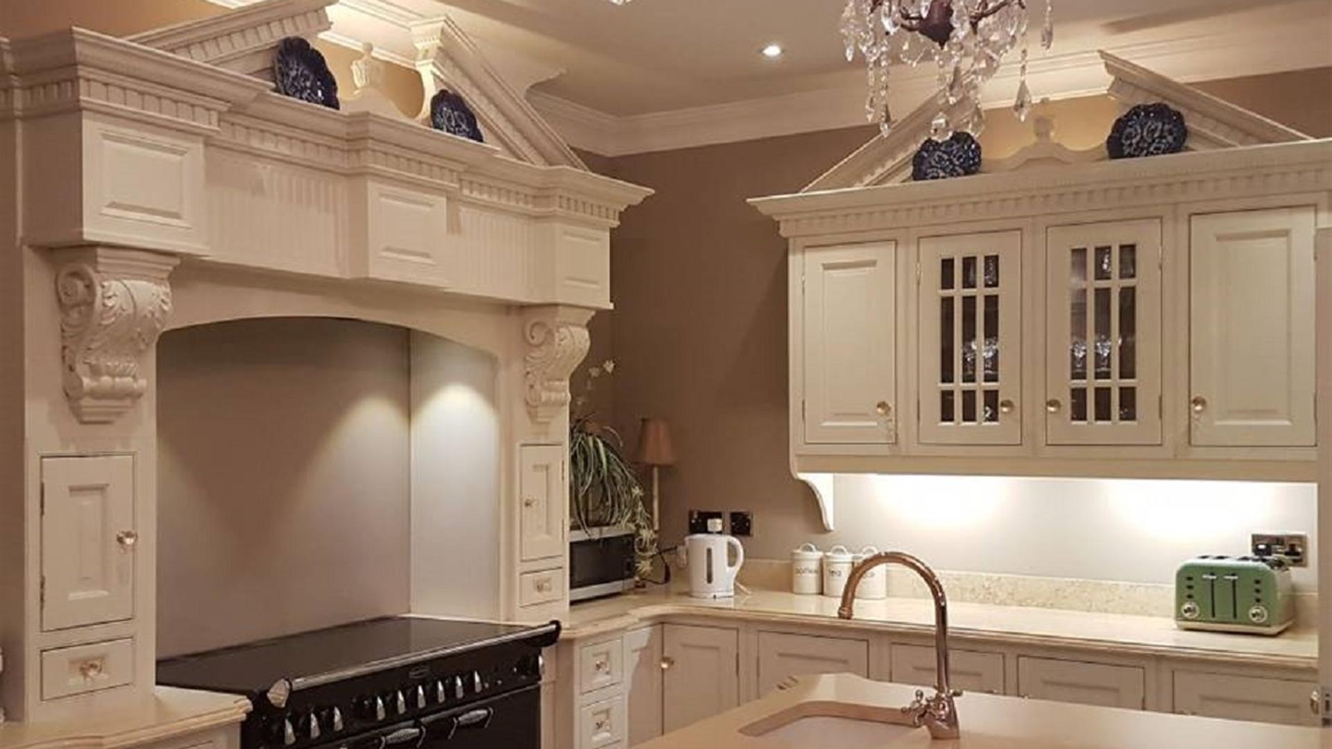 Modern Kitchen with range cooker, cream cabinets and sink in the island