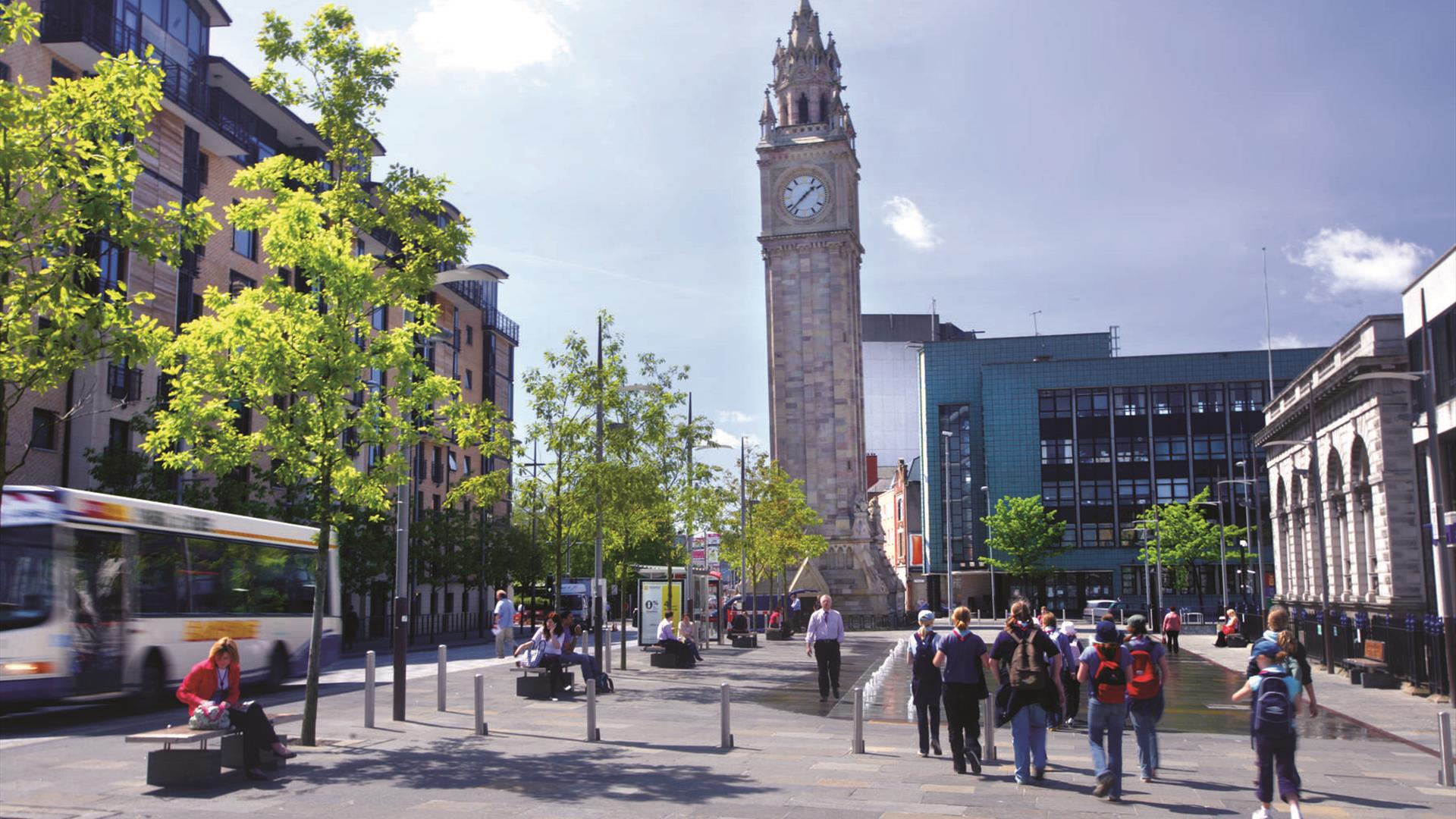 The Albert clock rising above the surrounding busy Belfast city area.