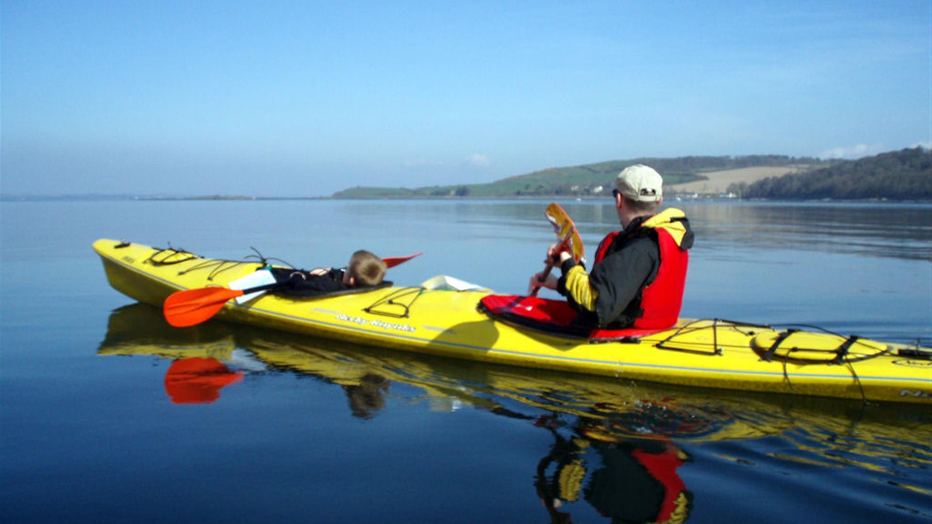 image of a young boy and a man in canoe out on the water