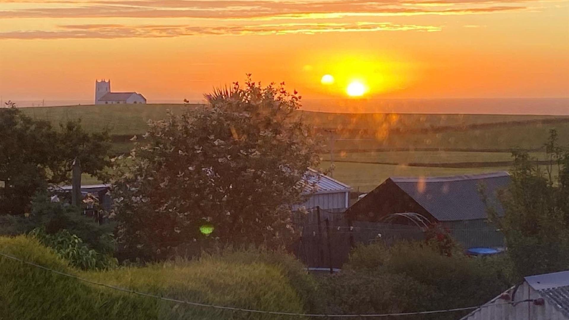 View from the back of the property at sunset looking Northwest towards famous whitewashed church