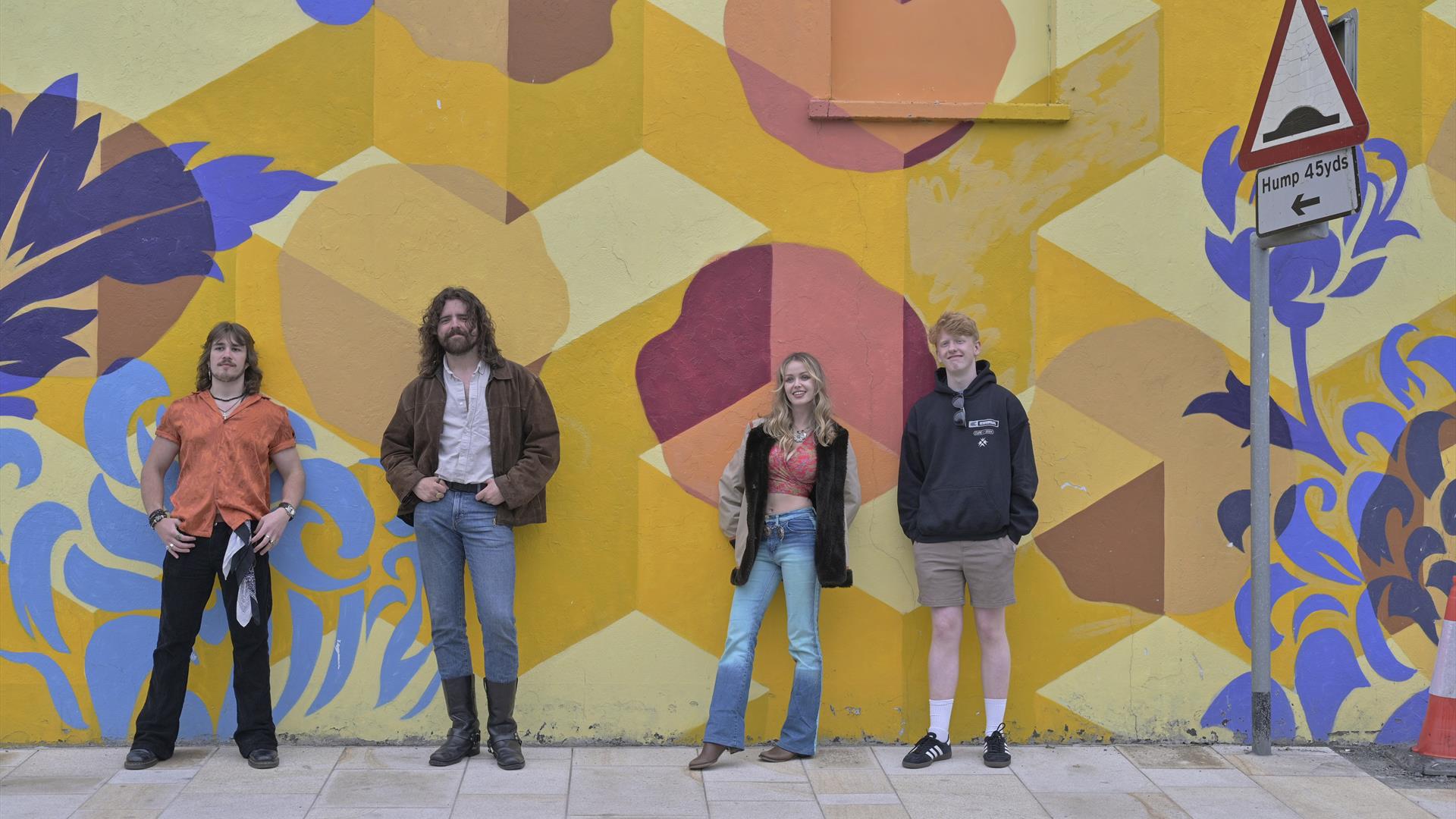 Banshee the overall winners from Buskfest 2024 pictured against street art in Banbridge.