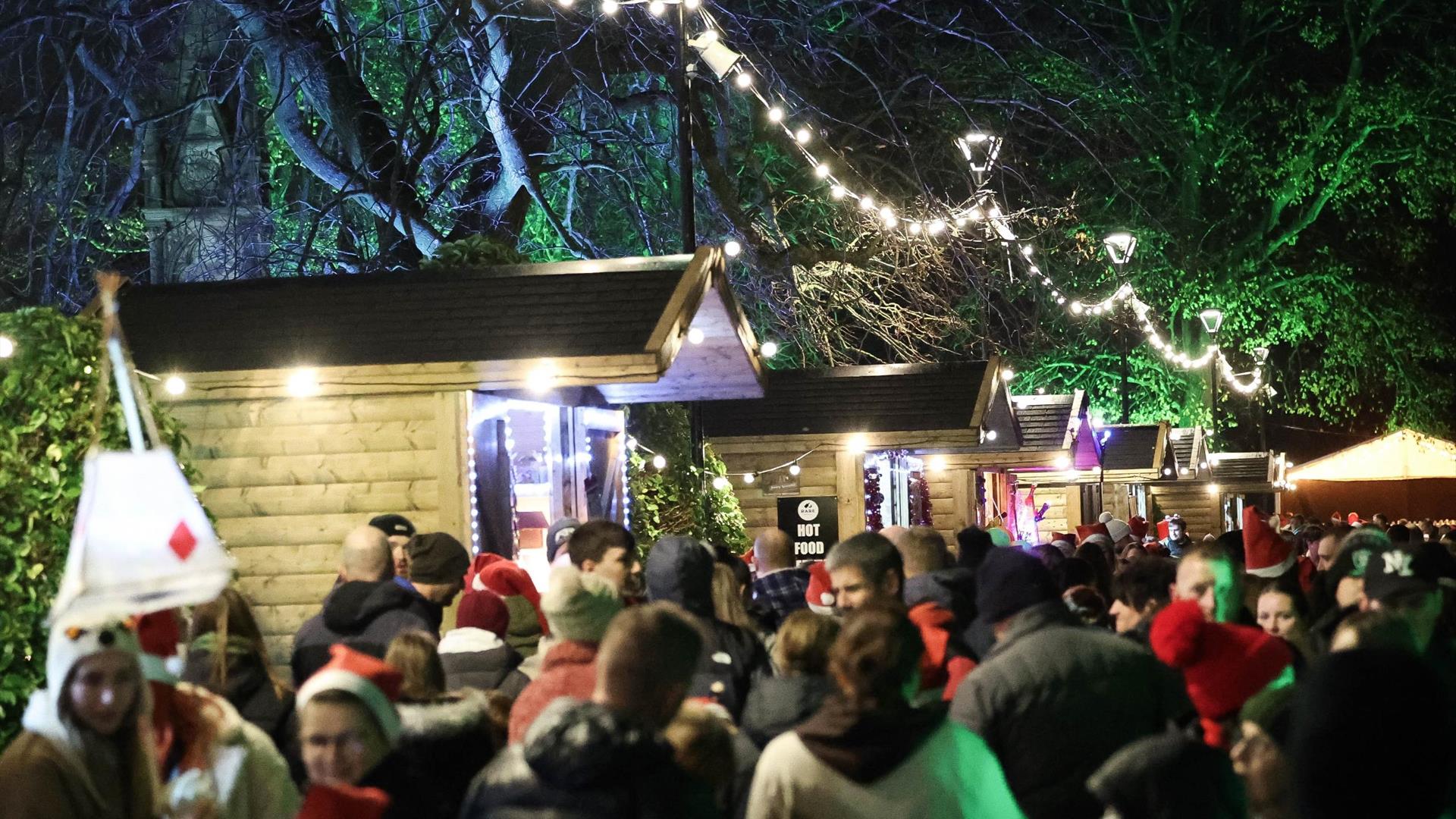 Image is of people enjoying the Christmas Market in Lisburn