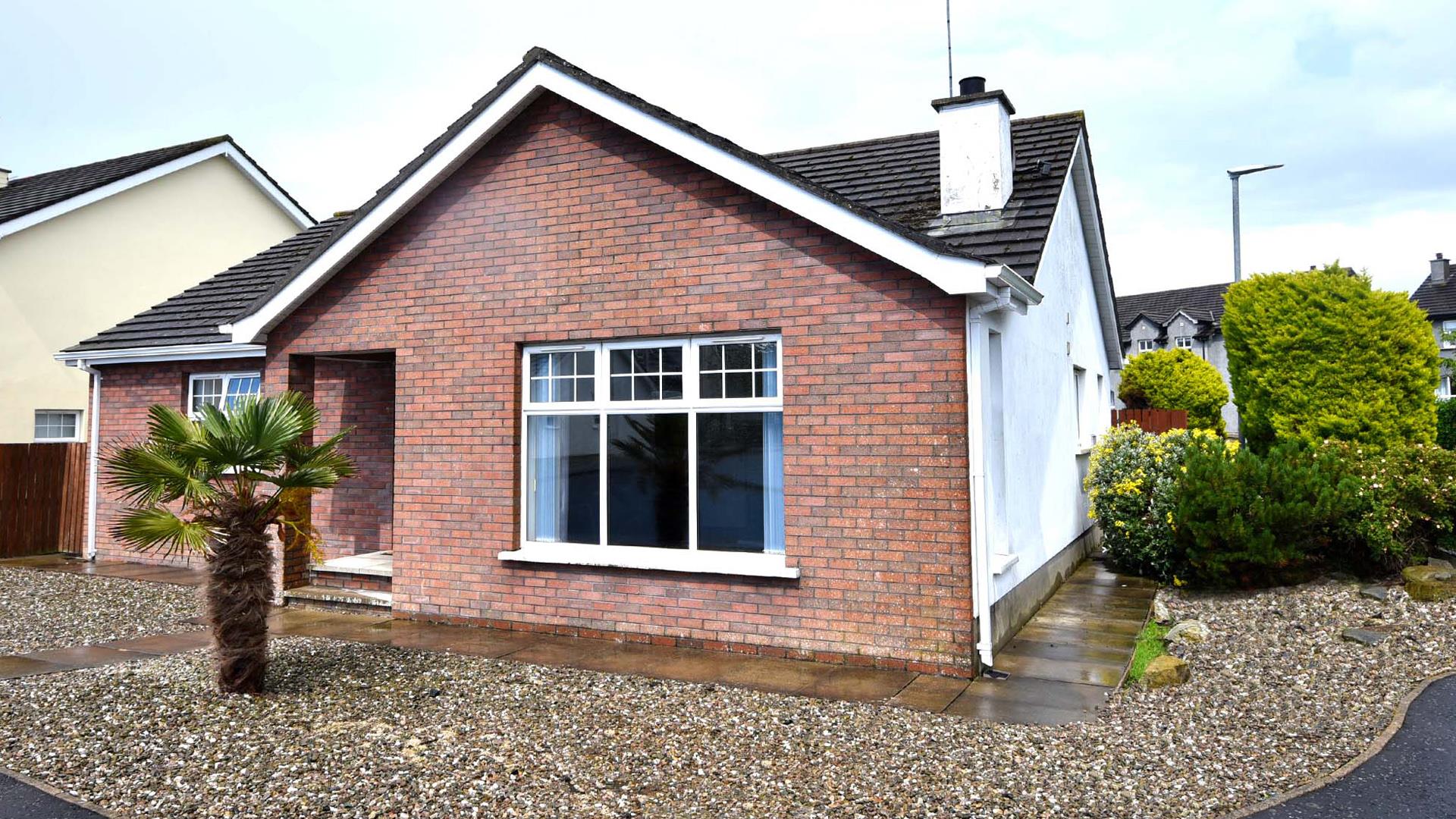 Exterior front and side view of Beachside Bungalow with gravelled drive and garden.