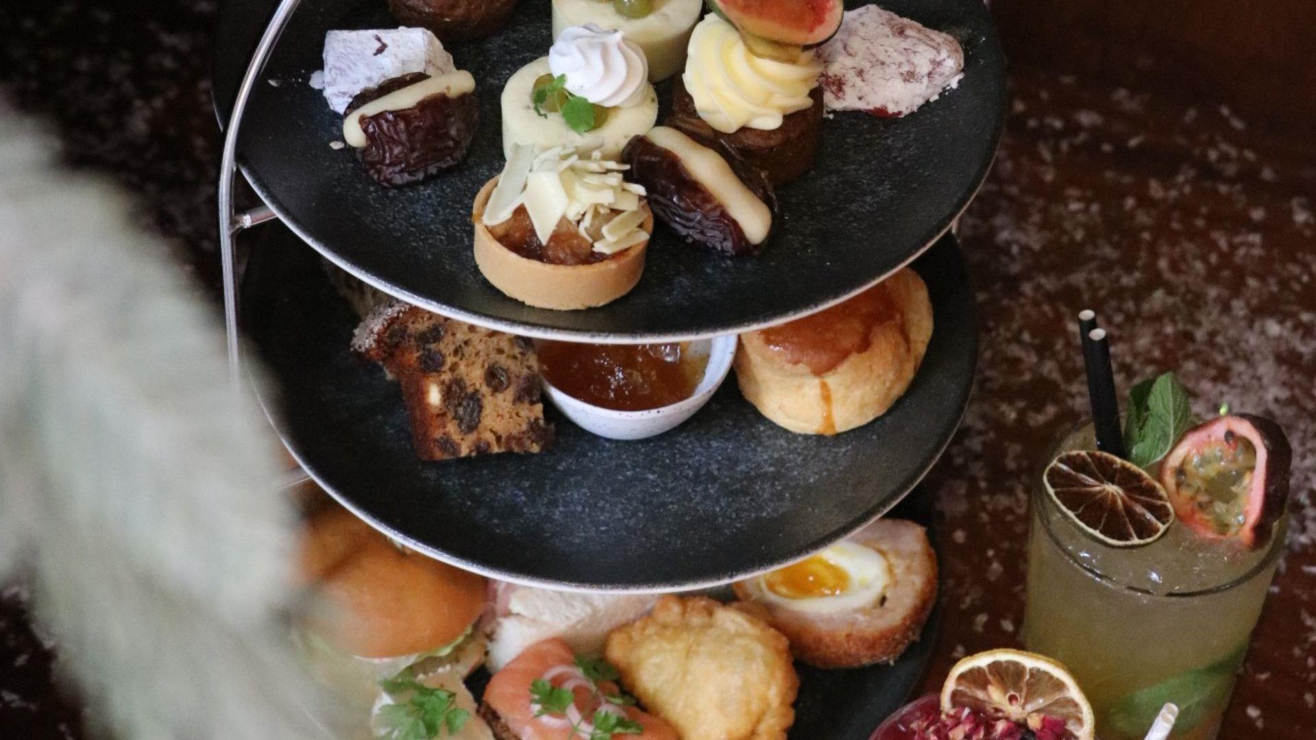 3 tier afternoon tea stand with savoury and sweet treats with cocktails & mocktails