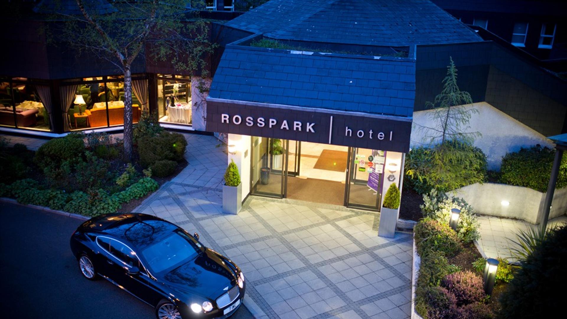 Night time exterior of entrance to Ross Park Hotel in Kells with car parked outside