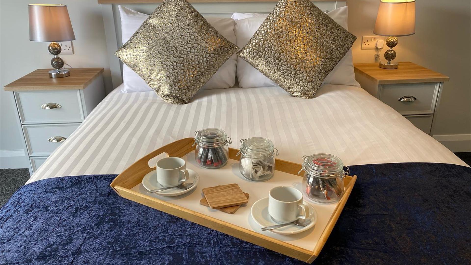 Image show breakfast tray on double bed in guest room