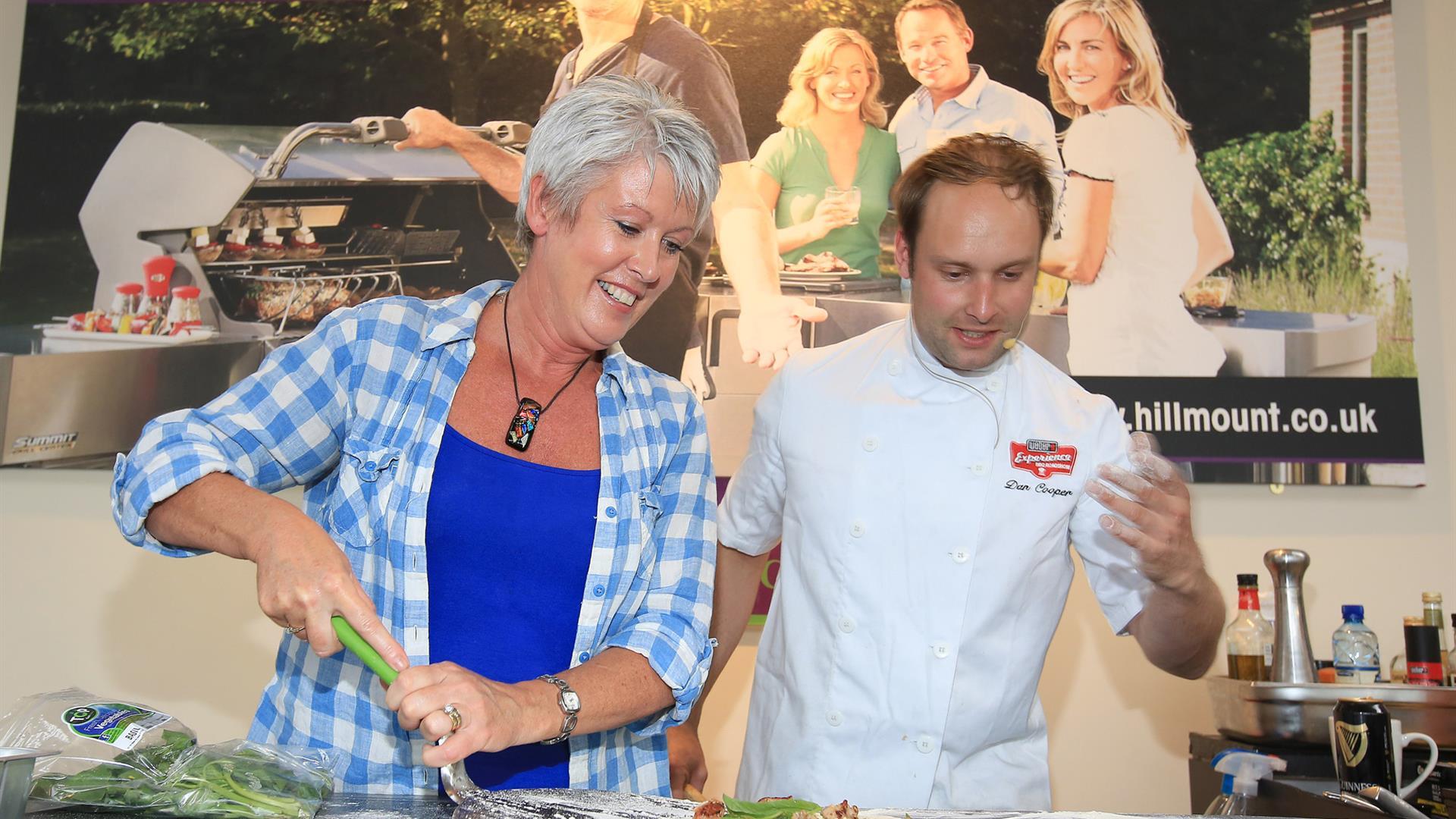 Image shows directing a lady who is cooking