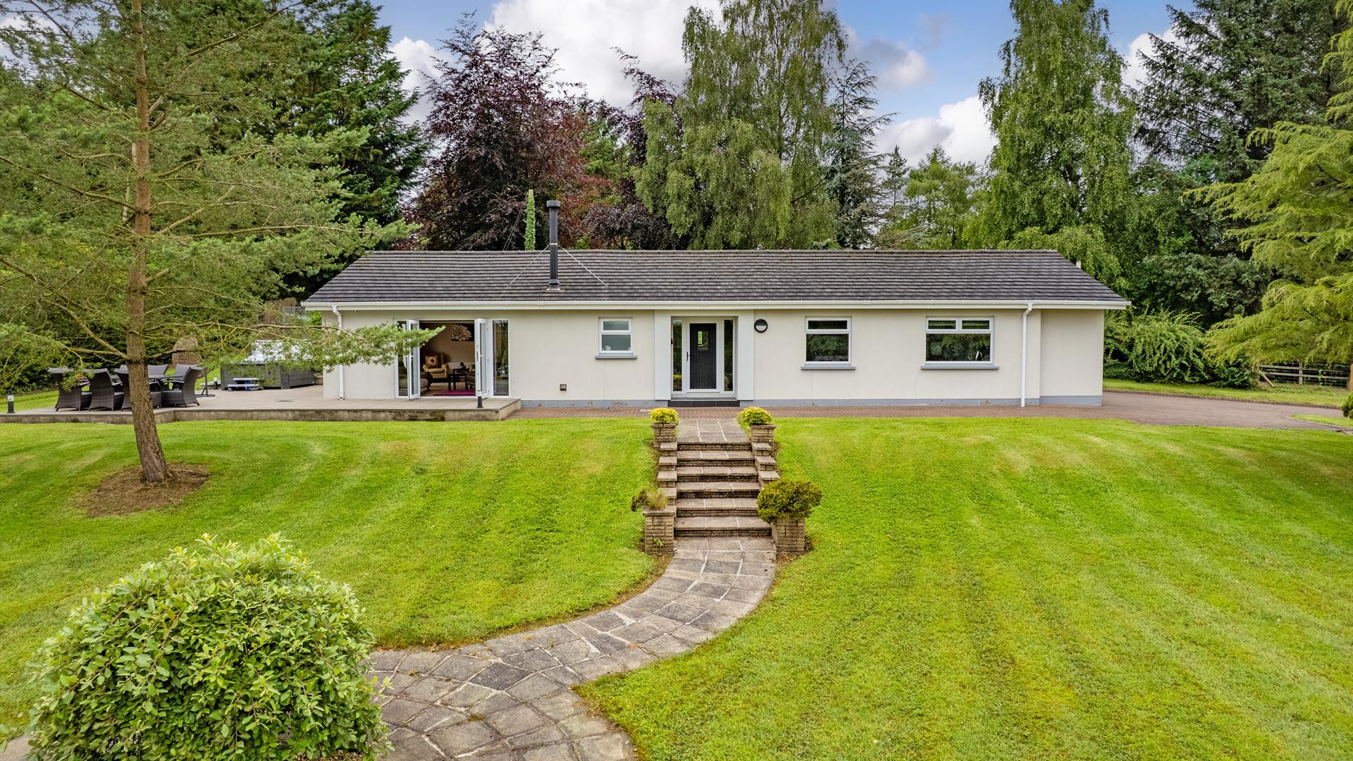 Photograph of front of house and green lawn