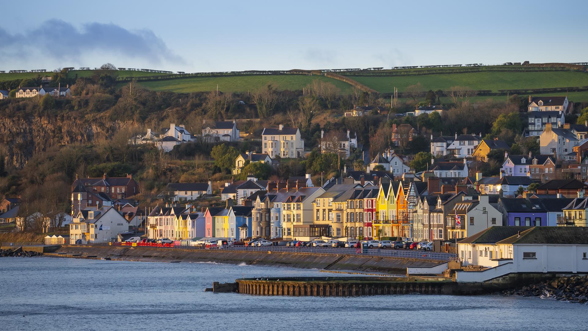 Whitehead promenade with coloured houses and old outdoor swimming pool