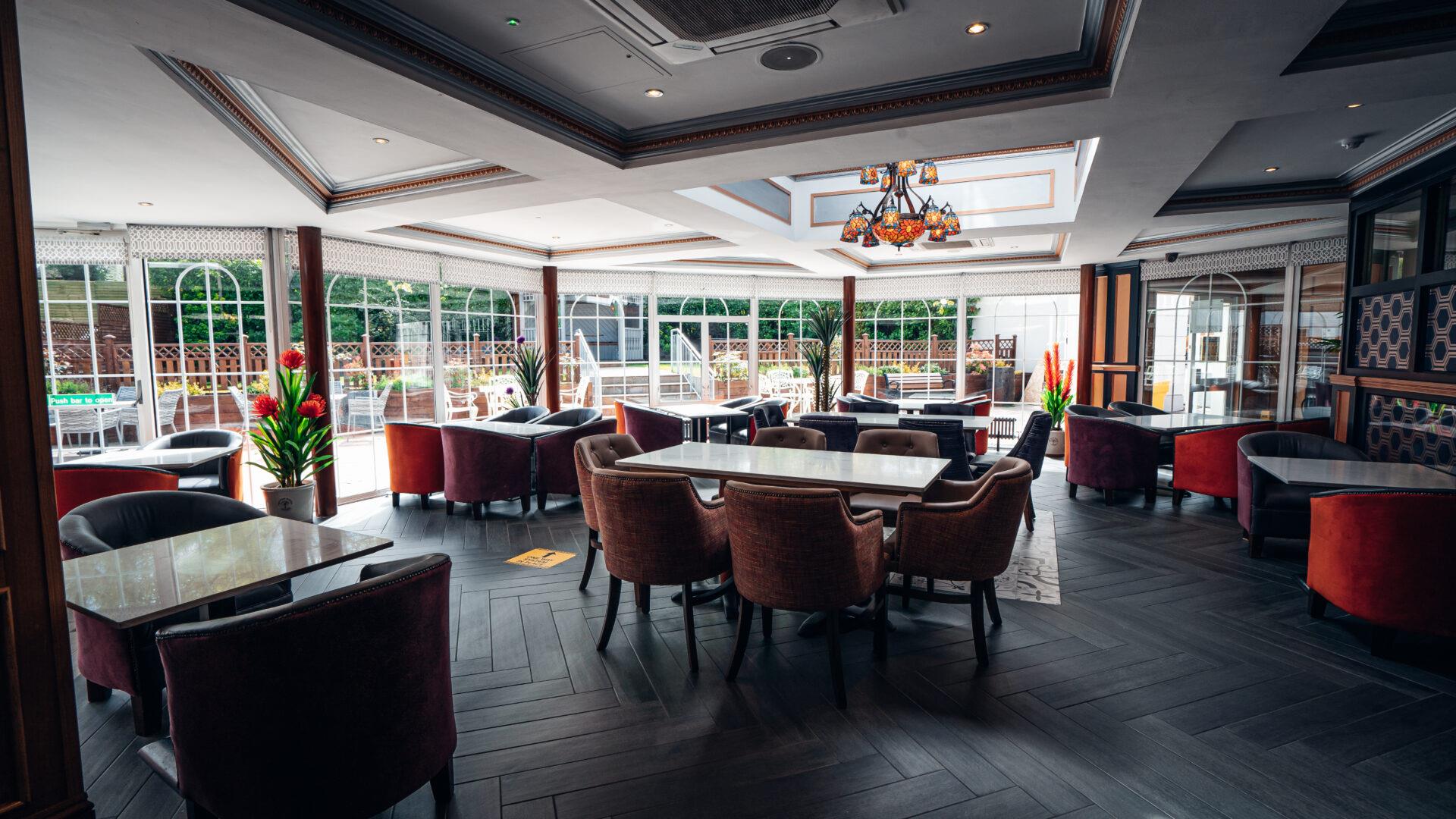 An image showing a dining room with a window wall out to an outside dining area.